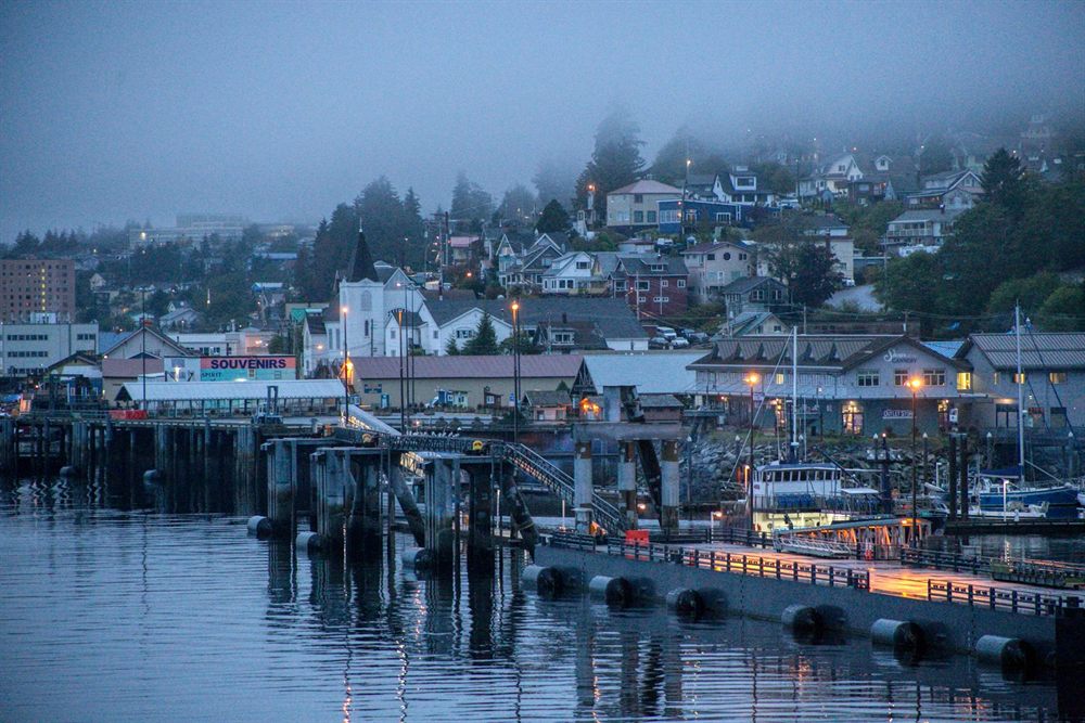 Foggy evening over the Ketchikan, Alaska waterfront with lights reflected in the harbor