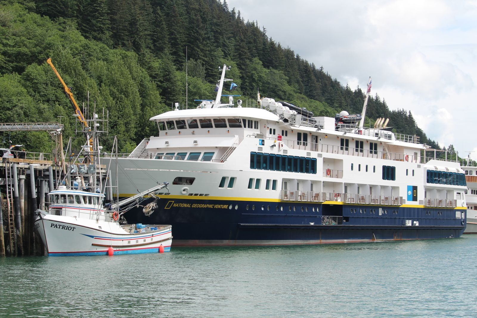 Small expedition cruise ship and a fishing boat docked in Skagway, Alaska, the kind of route US flagged cruise ships sail